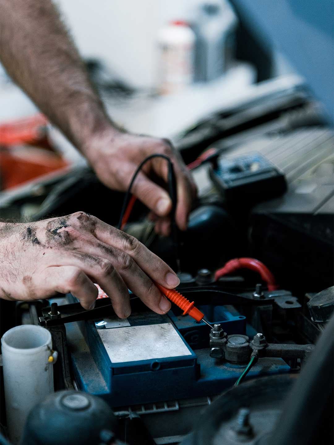 Close up of a mechanics hands in a car engine